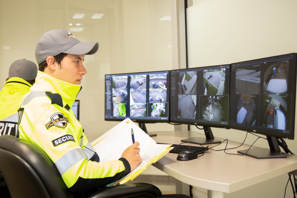 Flex Point Security's CCTV video alarm system response team sitting in an office with monitors