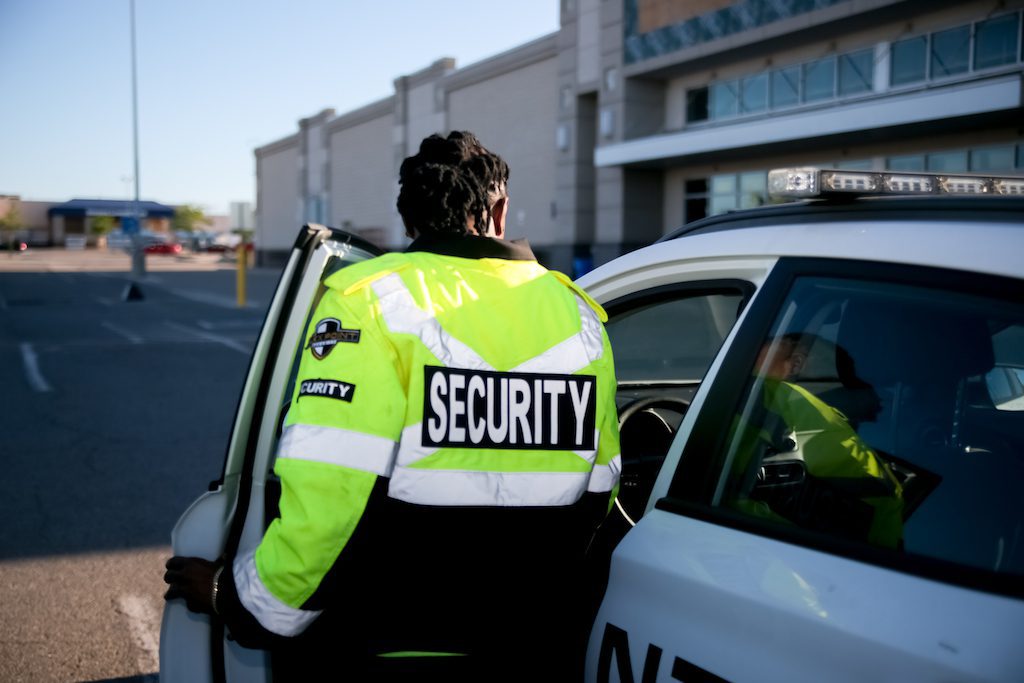 Flex Point Security guard entering company vehicle while on site at a warehouse