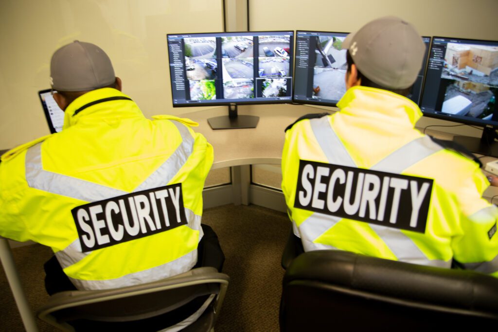 Two Flex Point Security professionals doing live monitoring of client's premises using computer monitors