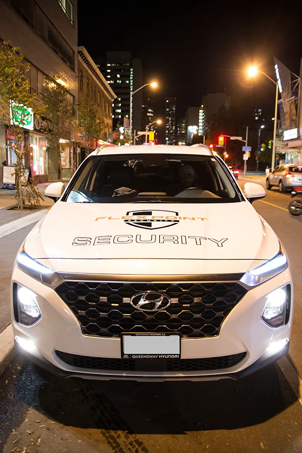 Close up of the hood of an alarm response Flex Point Security company branded vehicle parked in Toronto