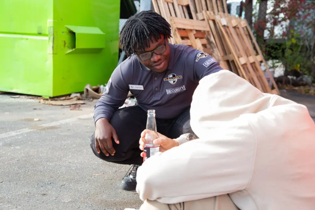 Flex point security guard helping someone holding a bottle
