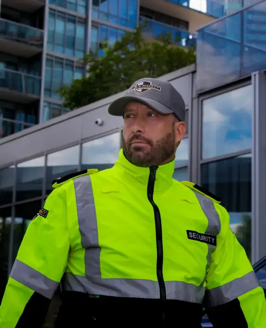 A male Flex Point Security guard walking outside of a condominium building Flex Point Security provides services for